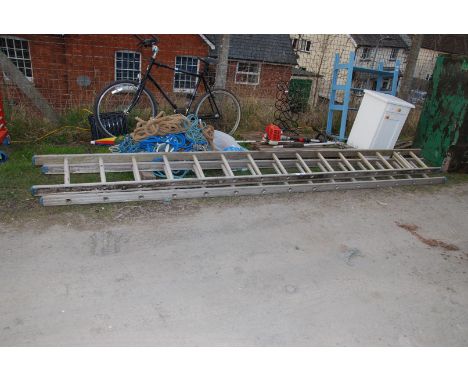 An aluminium double extending ladder.