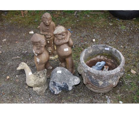 A concrete planter, duck, otter, etc. plus three golfers.