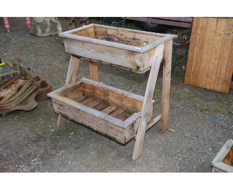 Two tier wooden planter, 33 1/2" wide  x 33" high x 24 1/2" deep.