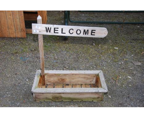 A wooden trough planter with "Welcome" sign, 28" x 12 1/2" x 8".