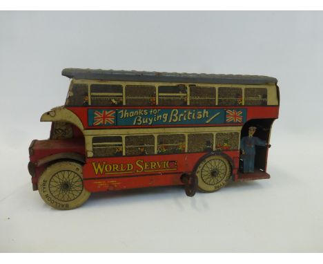 A tinplate clockwork model of a double decker London bus advertising the slogan "Thanks for Buying British".
