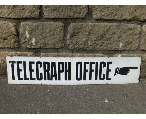 A narrow enamel sign- "Telegraph Office" with a pointing finger, 27 3/4 x 6".
