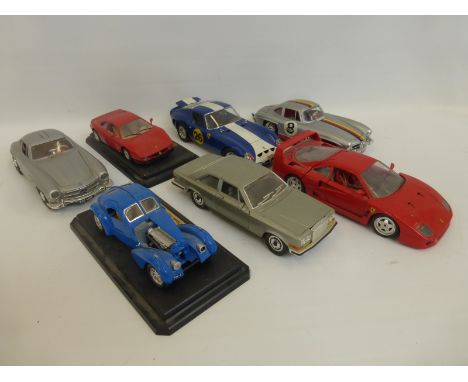 Seven assorted Burago 1/18 scale die-cast models including a 1954 Mercedes 300 SL, a 1962 Ferrari GTO etc.