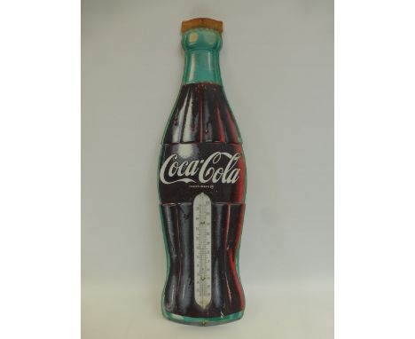 A decorative Coca-Cola tin thermometer, two tin 7UP signs and a circular "Lion tin sign.
