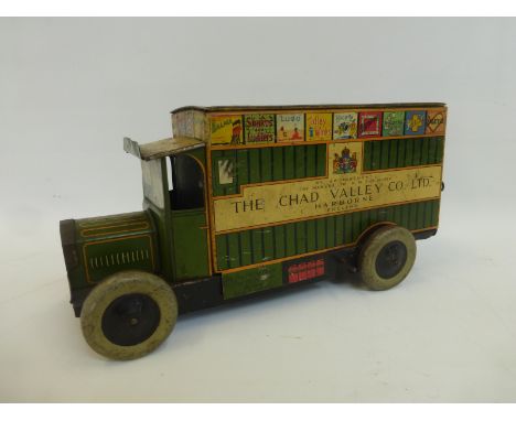 A Chad Valley Co. Ltd tinplate clockwork model of a delivery van decorated to the van roof with different board game designs.