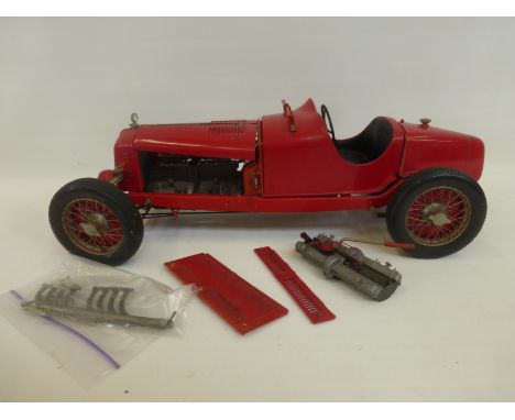 A large scale model of a 1930s Alfa Romeo P2 in racing red.