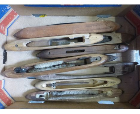 A box of wooden carpet textile cloth weaving loom shuttles.