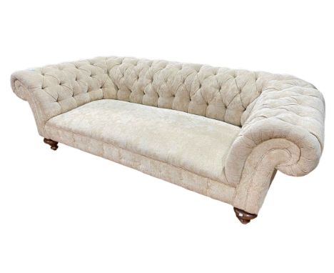 Chesterfield settee in deep buttoned light gold fabric.