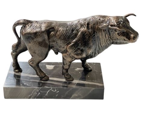 Bronzed model of a bull on marble stand.