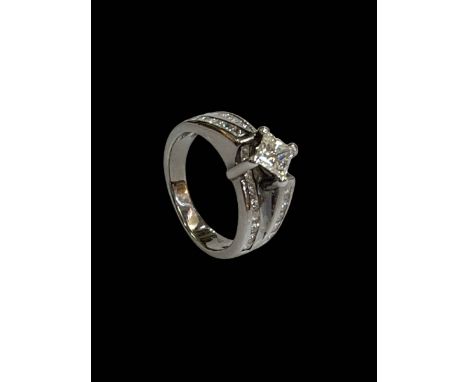 Diamond set 18 carat white gold ring having elevated square cut diamond above rows of 24 small square cut diamonds, size M.