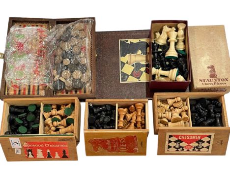Four chess sets including two in Staunton boxes, draughts and board.