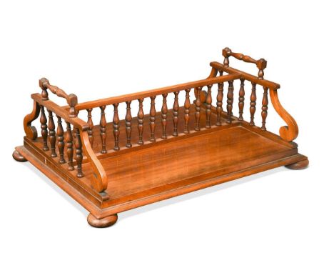 A mahogany book trough, 19th century, with spindle gallery and carrying handles raised on compressed bun feet20.5 x 51 x 41cm