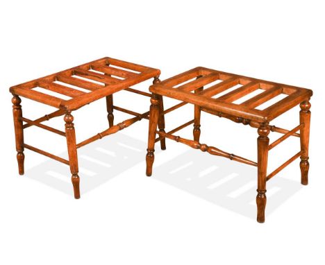 A near pair of Victorian stained beechwood luggage stands, each with four slats to the tops and turned tapering legs and cros