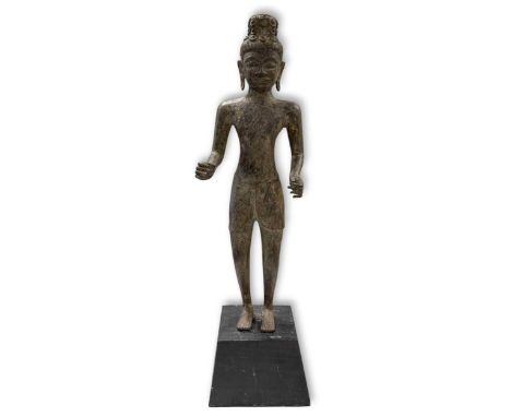 A large standing Prakhon Chai style standing bronze Buddhist figure, Thailand, on an associated ebonised wood stand69cm high