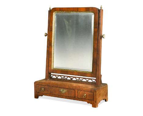 A walnut and boxwood banded dressing table mirror, 18th century, with soft bevelled plate above a pierced fretwork frieze, th