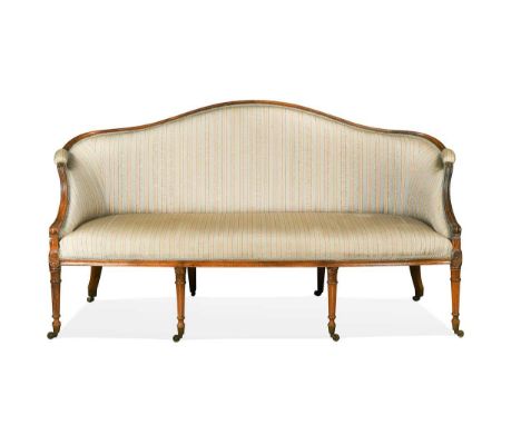 A George III beech framed camel back sofa in the Sheraton style, the moulded show frame with down swept arms on floral carved