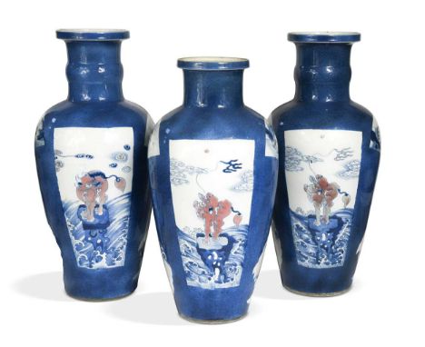 A garniture of three Chinese powder blue ground vases, Qing Dynasty, 18th/19th century, each decorated with panels highlighte