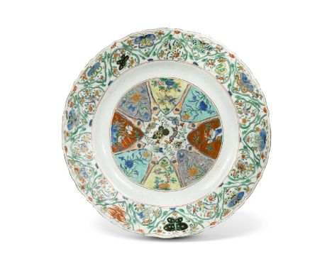 A Chinese famille verte porcelain charger, Kangxi Emperor (1662-1722), painted with a central eight pointed floral medallion 