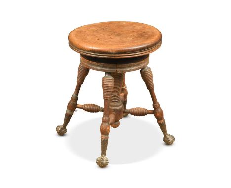 A mahogany and stained beech adjustable piano stool, circa 1900, possibly American, the circular rotating rise and fall top o