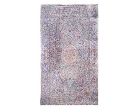 A large Persian carpet, probably Kirman, circa 1930  of intricate lotus flower design of pale madder and indigo on an ivory g