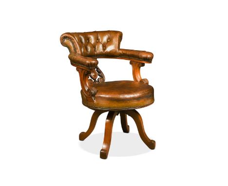 A Victorian walnut swivel desk chair, with horseshoe shaped back and central pierced cartouche splat, with leaf carved arm su