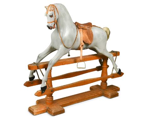 A carved and grey painted wooden rocking horse, early 20th century,  with glass eyes and real horse hair mane and tail, leath