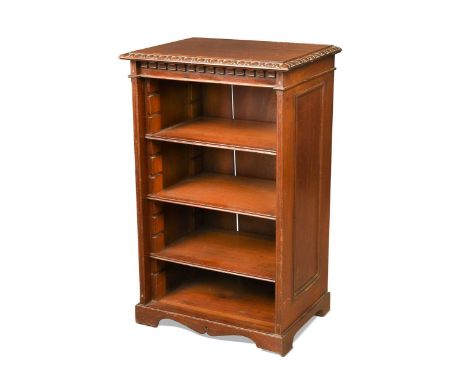 A late Victorian mahogany dwarf bookcase, the top with egg-and-dart carved edge and castellated frieze above four adjustable 