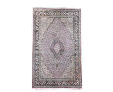 A finely-woven Tabriz carpet, late 20th century, with detailed millefiori central medallion within a border of alternate flor
