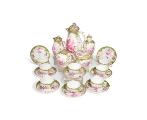 A fine Berlin tea service, the centres painted in puce camaieu with cherubs and flowers, within shaped green ground borders a