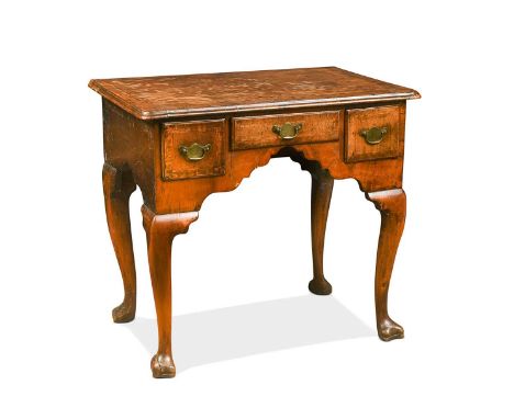 A walnut lowboy with pine sides, 18th century, the rectangular crossbanded top with a moulded edge, containing three frieze d