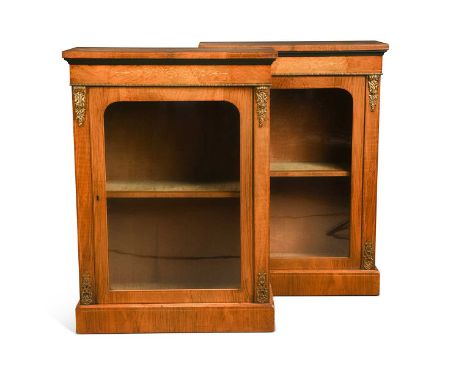 A pair of Victorian walnut pier cabinets, each with inlaid frieze over a single arched glazed door and gilt metal mounts104 x