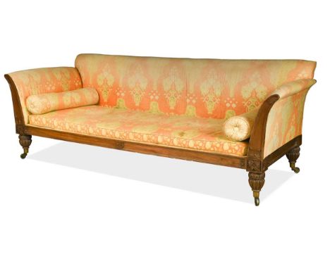 An early Victorian mahogany day bed, with gothic moulded frame flanked by rosettes on reeded lotus carved legs and castors 98