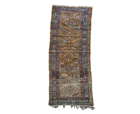 An antique wool Hamadan runner, with tobacco coloured ground and blue floral border307 x 97cm