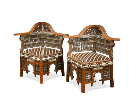 A pair of North African bone and ebony inlaid corner chairs, early 20th century, with mother of pearl inlaid top rails over m
