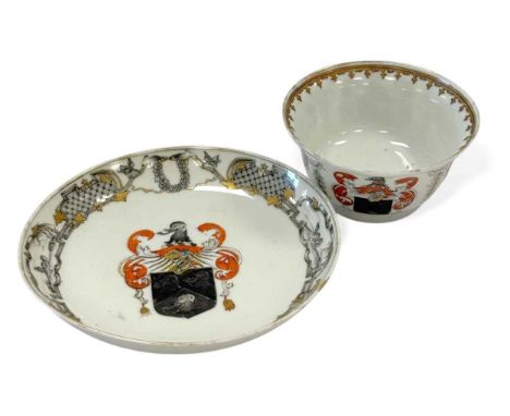 A Chinese armorial porcelain tea bowl and saucer, Qing Dynasty, circa 1750-60, with visor and elephant-headed central shield 
