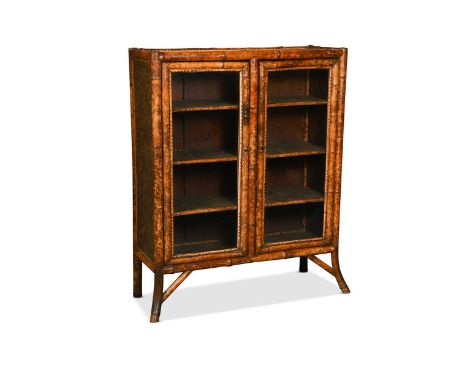 A bamboo cabinet, circa 1900, the top inset with lacquered panel decorated with birds over a pair of glazed doors104 x 83 x 3