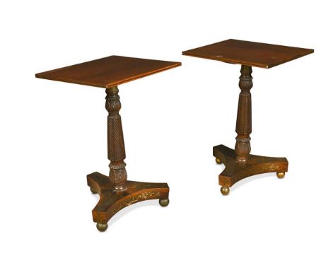 A pair of Regency rosewood side tables, the column decorated with carved acanthus leaves on a triform base decorated with bra