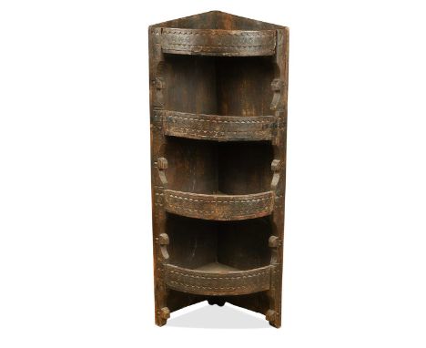 An Anglo-Indian carved hardwood corner shelf, 19th century, bow fronted with four open shelves128 x 39cm