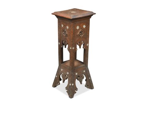 A Syrian carved wood jardiniere stand, early 20th century, decorated all over with scrolling foliage, the square top on flora
