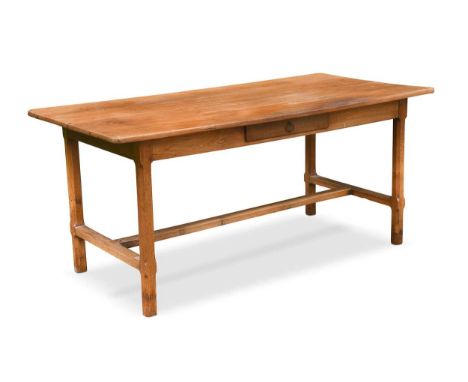 A fruitwood and oak farmhouse table, late 19th century, the four plank top over a single frieze drawer on chamfered legs unit