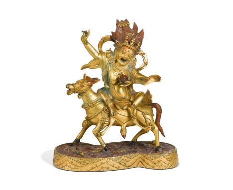 A Tibetan style gilt-bronze figure of Palden Lhamo on a mule, the fierce red haired deity with bulging eyes, the mule stood o