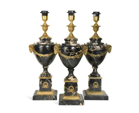 Three Louis XV style gilt metal mounted black marble table lamps, 20th century, each of urn form with applied swags and rams 