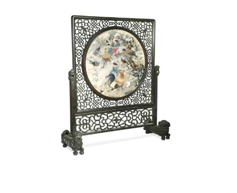 A Chinese firescreen,  the intricately carved and pierced surround with lion finials and supports, the circular embroidery wi