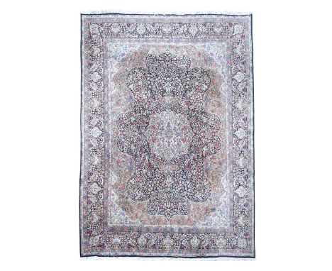 A finely-woven Persian wool carpet, late 20th century, to a Kasmir design, the intricate field with central indigo medallion 