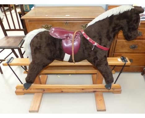 A child's modern plush rocking horse with swing action, by Galt