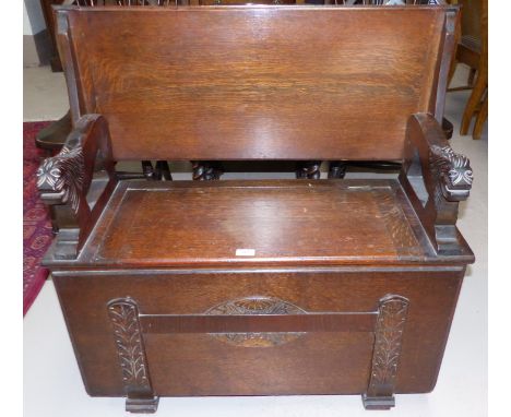 A 1930's oak box seat monk's bench with carved decoration