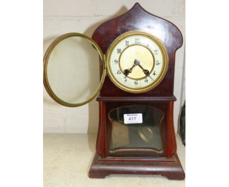 An Edwardian mahogany ogee arch top mantel clock with striking movement