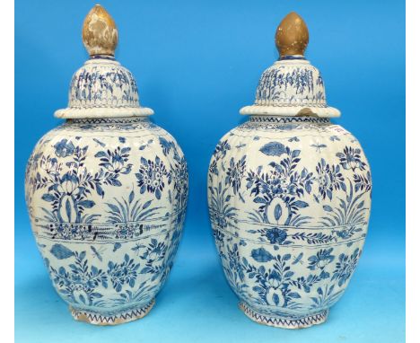A pair of late 17th/early 18th century ting lazed Delftware covered vases of octagonal form decorated in the Chinese manner w