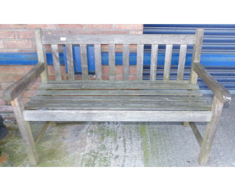 A teak slatted garden bench