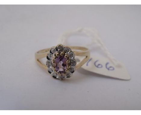 9ct oval amethyst and diamond   cluster ring approx size M       